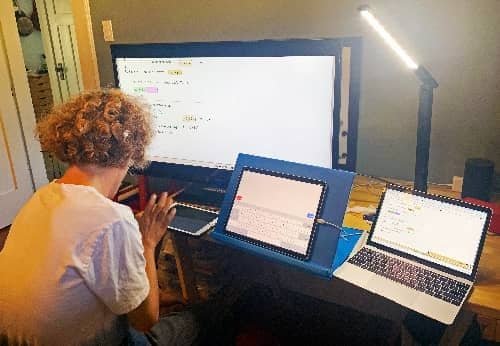 Scott doing school work at his desk.